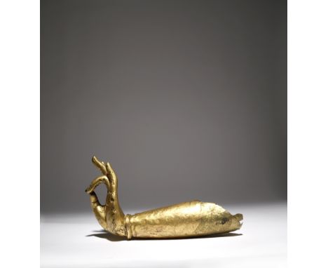 A GILT-COPPER BODHISATTVA'S ARM 17TH CENTURY OR EARLIER The hand held in kartari mudra, with a simple bangle to the wrist, 28