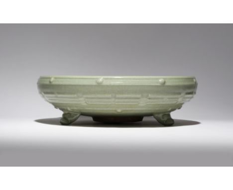 A CHINESE LONGQUAN CELADON TRIPOD INCENSE BURNER MING DYNASTY The shallow body decorated in relief with raised bosses and tri