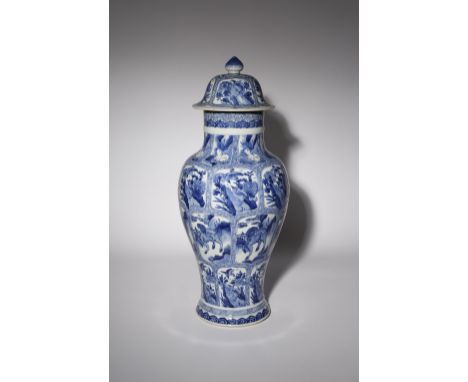 A CHINESE BLUE AND WHITE MOULDED BALUSTER VASE AND COVER KANGXI 1662-1722 Painted with four rows of cartouches enclosing rabb