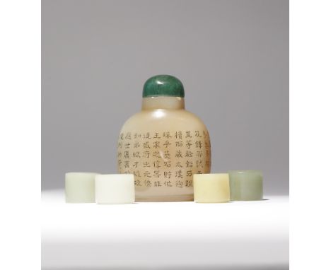 FOUR CHINESE JADE ARCHER'S RINGS AND A BOWENITE SNUFF BOTTLE LATE QING DYNASTY One archer's ring carved in white jade, anothe