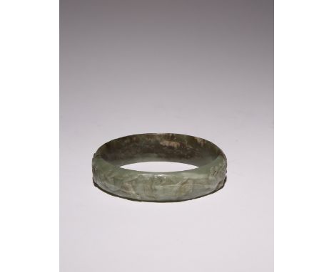 A CHINESE CELADON JADE 'EIGHT HORSES' BANGLE QING DYNASTY OR LATER Carved to the exterior with the Eight Horses of Mu Wang re