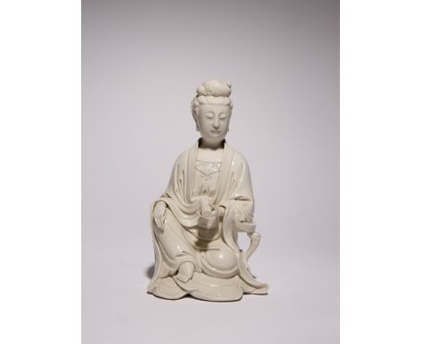A CHINESE BLANC DE CHINE FIGURE OF GUANYIN PROBABLY REPUBLIC PERIOD She sits with one hand resting upon her raised knee, she 