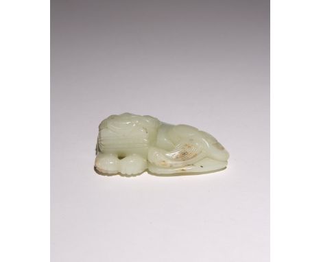 A CHINESE PALE CELADON JADE CARVING OF A LION DOG QING DYNASTY The mythical beast depicted reclining with its head resting up