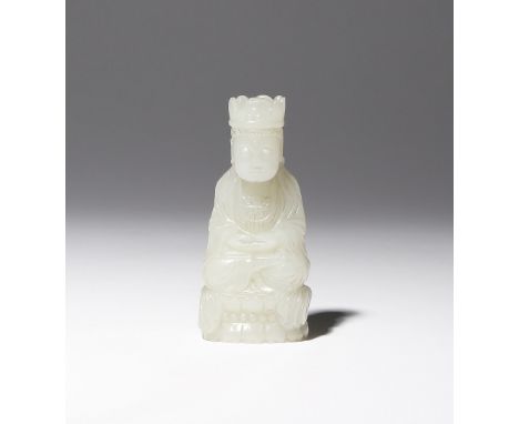 A CHINESE PALE CELADON JADE CARVING OF GUANYIN QING DYNASTY Depicted seated in dhyanasana upon a beaded double lotus throne, 