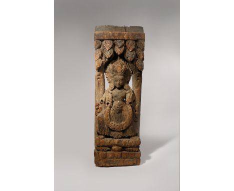 A NEPALESE CARVED WOOD ARCHITECTURAL FRAGMENT C.12TH CENTURY Worked in relief with a deity standing between two pillars in an
