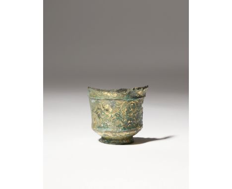 A SMALL CHINESE SILVER-GILT CUP TANG DYNASTY Finely decorated to the exterior with scrolling tendrils on a matted ground, wit