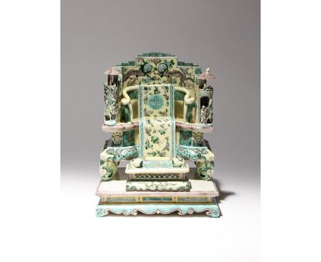 A CHINESE FAMILLE JAUNE PORCELAIN MODEL OF A THRONE 19TH CENTURY The elaborate throne decorated with mythical beasts and flow