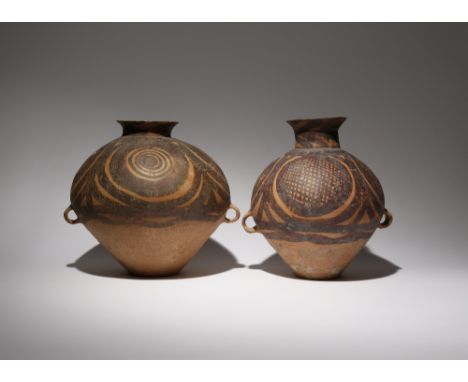 TWO CHINESE POTTERY VASES NEOLITHIC Each surmounted by a waisted neck and tapering towards the foot, painted in black and red