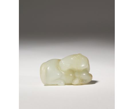 A CHINESE CELADON JADE CARVING OF A HORSE QING DYNASTY The recumbent animal depicted gazing over its back, finely incised wit