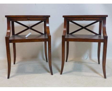 A pair of Regency style mahogany lamp tables, with brush slides, raised on sabre legs, H.60 W.41 D.38cm 