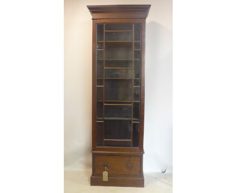 A Georgian style tall narrow bookcase, with glazed door above 1 drawer, raised on stepped base, H.213 W.72 D.37cm 