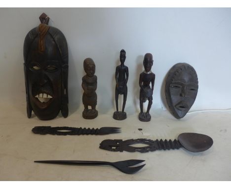 A collection of 20th century hand-carved African wooden items to include a mask, a mask lamp, 3 sculptures and 3 serving uten