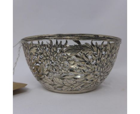 A rare Chinese pierced silver bowl by Yu Chang, the sides decorated with chrysanthemums and cash medallions to the foot, circ