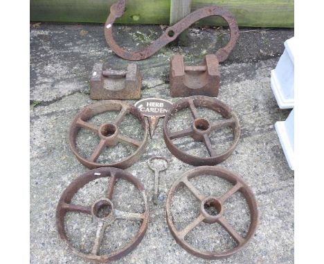 A set of four iron trailer wheels, 32cm, together with two iron weights, an S-shaped wall bracket and metal sign (8)
