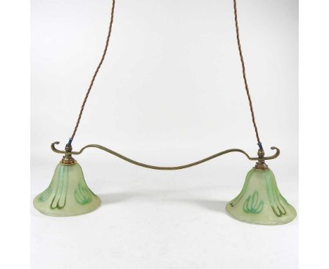 An Art Nouveau style brass ceiling light, with green glass shades and adjustable height, with counterweight balance, 63cm wid