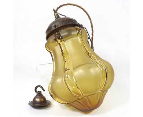An amber coloured glass pendant light, 33cm high, with chain and ceiling rose