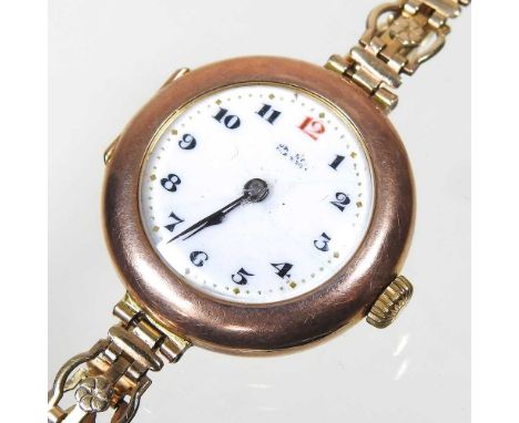 An early 20th century ladies 14 carat gold cased wristwatch, with an enamel dial, on a later gilt strap, 21g gross, cased