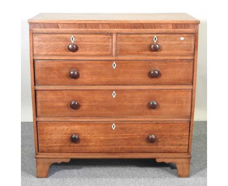 A George III light oak chest, containing two short over three long drawers, on bracket feet. Note: a non-transferable ivory e