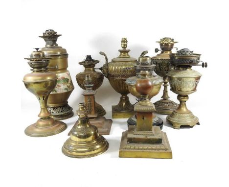 A collection of ten various brass oil lamp bases, highest 43cm