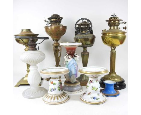 A collection of eight various oil lamp bases, to include brass and porcelain, highest 52cm (8)