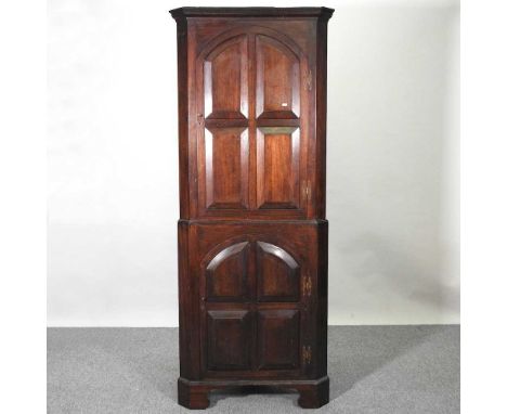 A Georgian style oak standing corner cabinet, early 20th century, on bracket feet78w x 197h x 47d cm