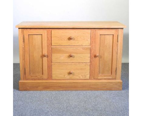 A modern light oak sideboard, on a plinth base120w x 51d x 75h cm