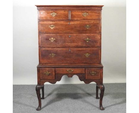 An 18th century oak chest on stand, with a shaped apron, on cabriole legs101w x 53d x 153h cmOverall solid and usable. The dr