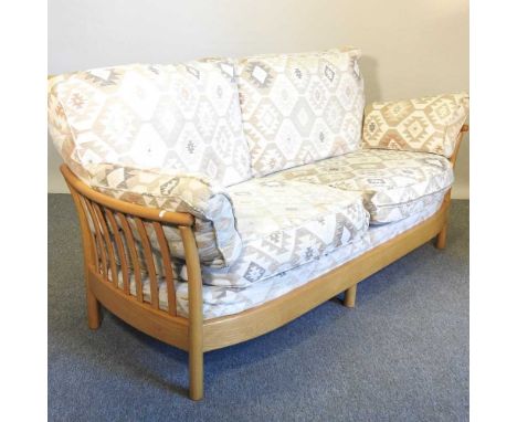 An Ercol light elm sofa, with loose cushions195w x 95d x 90h cm