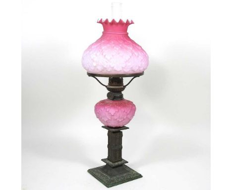 A Victorian brass oil lamp, with a pink satin glass reservoir and matching shade, in the manner of Fenton, 41cm high