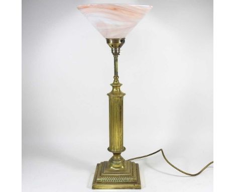 A brass lamp, with a fluted stem and opaque glass shade, 60cm high