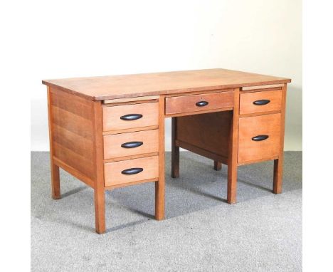 A mid 20th century light oak pedestal desk138w x 76d x 76h cm