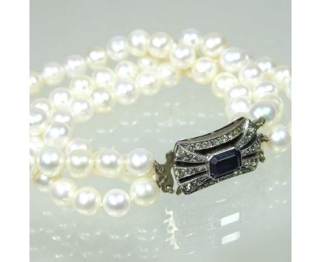 A three strand cultured pearl bracelet, with a gem set silver clasp, 17cm longOverall condition is complete and the stringing