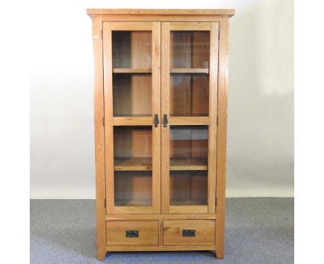 A light oak display cabinet, fitted with shelves, with drawers below100w x 40d x 180h cm