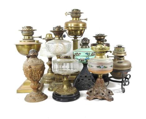 A collection of ten mainly brass and glass oil lamp bases, highest 57cm (10)