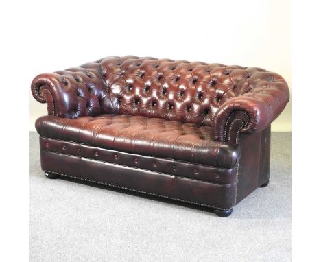 A red leather button back chesterfield sofa, with a buttoned seat172w x 95d x 70h cm
