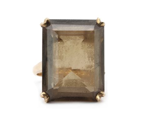 A gold single stone smoky quartz ring, an emerald cut smoky quartz, approximately 20 x 15mm, claw set to open shoulders and a