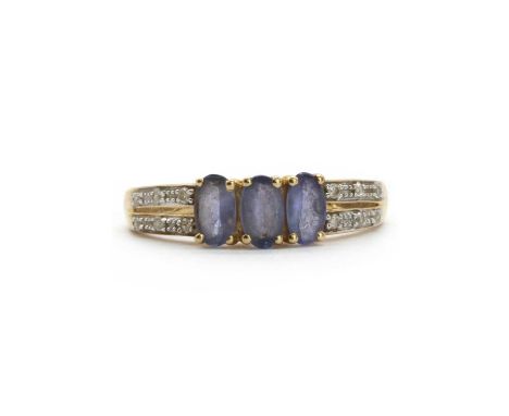 A 14ct gold tanzanite and diamond ring, a row of oval mixed cut tanzanites, to split shoulders grain set with brilliant cut d