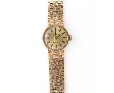 A ladies' 9ct gold Tissot 'Stylist' mechanical bracelet watch, 17mm diameter with a gilt dial and baton hour markers, to inte