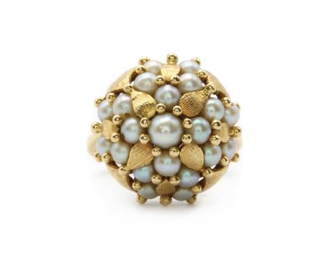 A gold cultured pearl cluster ring,a bombé cluster of cultured pearls with gold bead and foliate decoration, to pierced baske