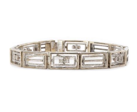 A 14ct white gold diamond set bracelet,rectangular gate style links, alternating links illusion set to the centre with pairs 