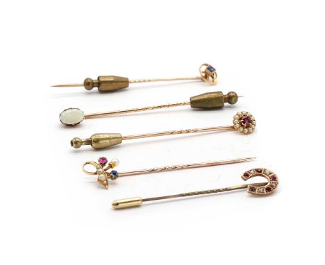 A collection of stick pins, comprising a 9ct gold paste and split pearl horseshoe stick pin, the finial hallmarked Birmingham