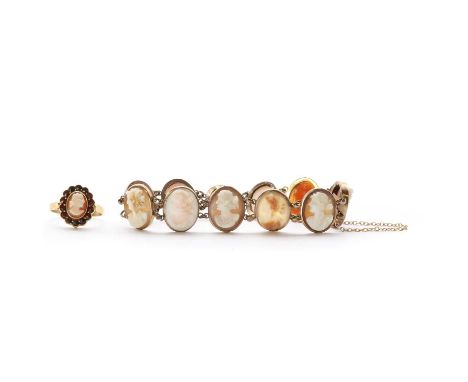 A gold mounted shell cameo bracelet, a series of shell cameo, rub set and joined by jump rings, to box clasp and safety chain