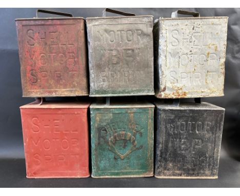 Six 2-gallon petrol cans with caps including BP and Shell. 
