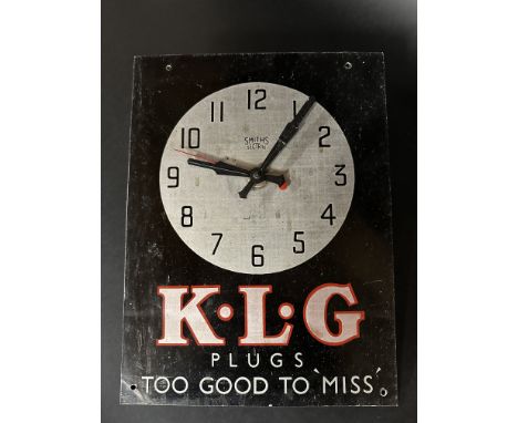 A Smiths Sectric tin fronted wall clock, with advertising for KLG Plugs, 10 1/2 x 14".