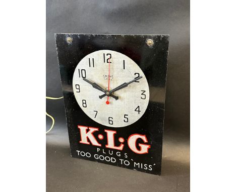 A Smiths Sectric wall hanging electric clock, advertising KLG Plugs, 10 1/2 x 14".