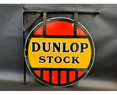 A Dunlop Stock circular double sided enamel sign in good condition, hanging on a wall bracket, the sign is 18" diameter.