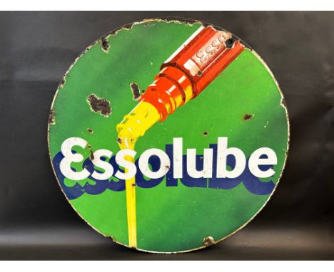 An Essolube circular double sided enamel sign with an image of oil pouring from a bottle, 26" diameter.
