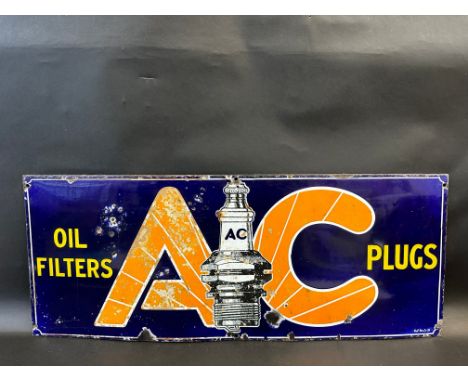 An AC Oil Filters and Plugs rectangular enamel sign with central spark plug image, 30 x 12".