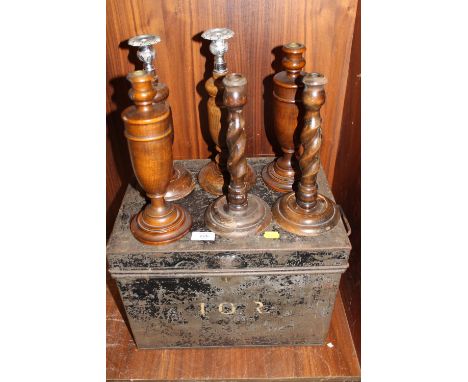 A PAINTED BLACK METAL TRUNK TOGETHER WITH SIX WOODEN CANDLE STICKS 
