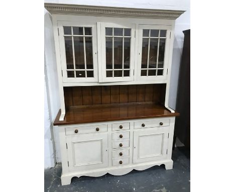 Modern dresser, cream painted with three glazed doors enclosing shelves, above sideboard of seven assorted drawers and two cu